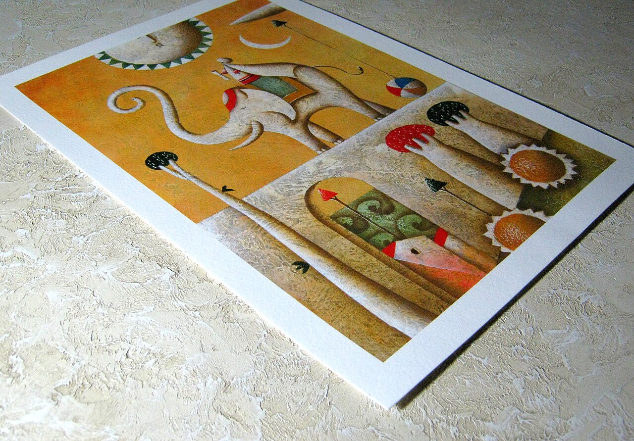 A fine-art print on white paper with a wide margin, resting at an angle on a textured surface